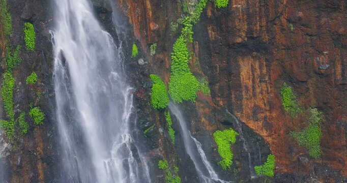 Close-Up Detail of Tumpak Sewu Waterfall Cascading Over Mossy Cliff, Indonesia