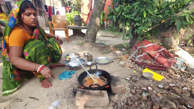 Rural Indian Woman Cooking Outdoors in Traditional Village Kitchen, Preparing Food on Wood Fire Chulha, Authentic Indian Lifestyle, Culture and Rural Life