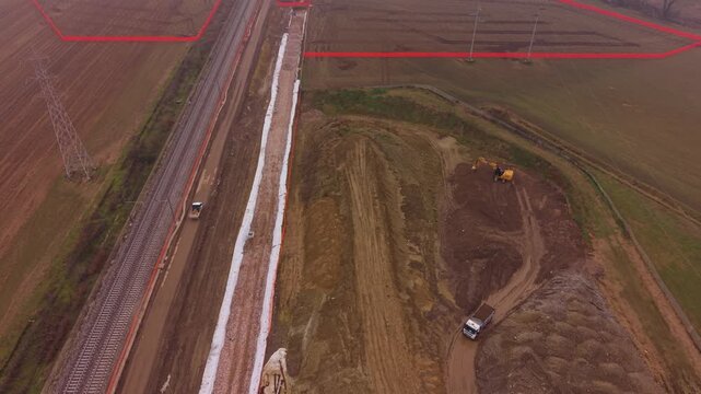 Construction Site Aerial View: Capturing a bird's-eye perspective of a bustling construction site, where heavy machinery and earthworks indicate the progress of a large-scale project.