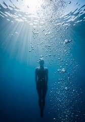 Dynamic view of a body streamlined underwater, capturing brilliant sun rays filtering down through the surface with numerous streams of effervescent bubbles, ripple, depth, pool