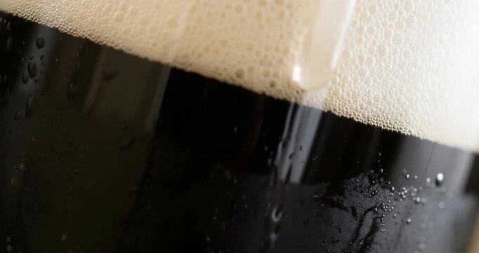 AI-generated cinematic macro shot of a cold beer glass with condensation droplet sliding slowly down the surface &mdash; evoking thirst, craftsmanship, and the irresistible perfection of premium refreshment