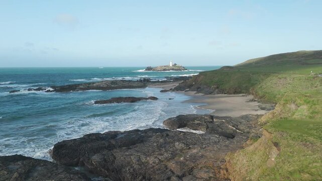 drone shot of cornwall lighthouse along the coastline during the day   