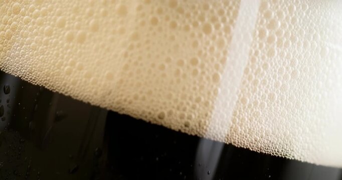 Ultra close-up of rich creamy froth cascading over a dark beer glass, capturing the appetizing texture, golden foam, and indulgent freshness of premium craft brewing in high-end cinematic AI detail. 