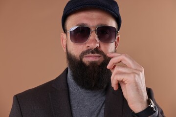 Man with mustache and beard on beige background