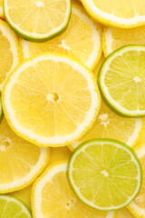 Fototapeta premium Fresh lime and lemon slices as background, top view