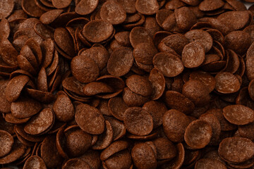 Corn-flakes background and texture. Chocolate cereal.