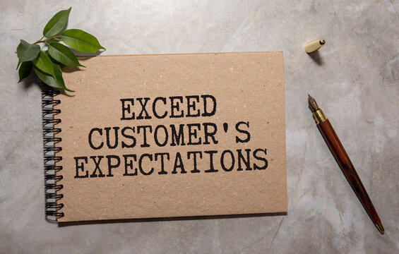 Close-up Of Red Tick Placed On Exceed Expectation Over Paper