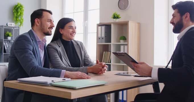 Couple shaking hands with professional broker, having good business financial deal, signed contract of purchasing, discussing future plans in professional setting. Finalization of the agreement, 