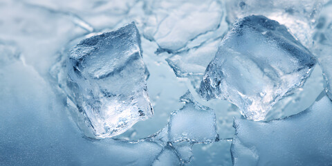 Obraz premium Clear ice cubes on frozen surface with cracked texture