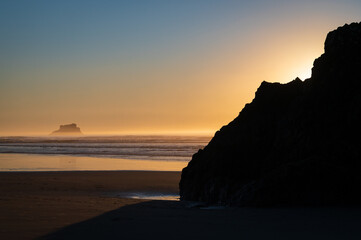 Sunset along the Pacific Ocean at the beach called Arch Cape about four miles from Cannon beach. Nature lovers will enjoy tide pooling and beachcombing at Arch Cape State Park.