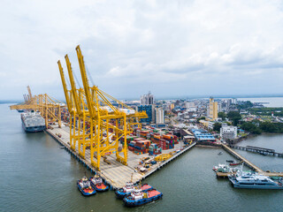 Obraz premium Buenaventura industrial port aerial view with yellow cargo cranes and containers
