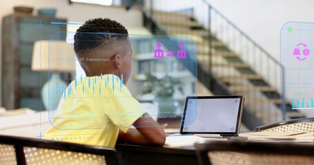 Sitting boy wearing yellow t-shirt leaning toward tablet on wooden table at home, with AR overlays