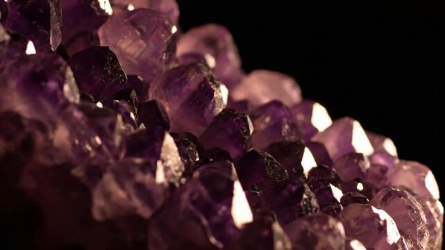 Close-up of sparkling mineral crystals Detail shot of a cluster of small, angular mineral crystals, catching the side light to reveal their facets and internal refractions.