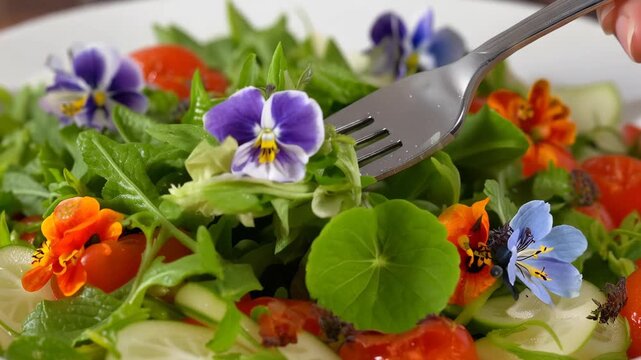 Macro shot of a fork picking up a vibrant spring salad with edible flowers, bright natural lighting, professional food photography, healthy vibe.