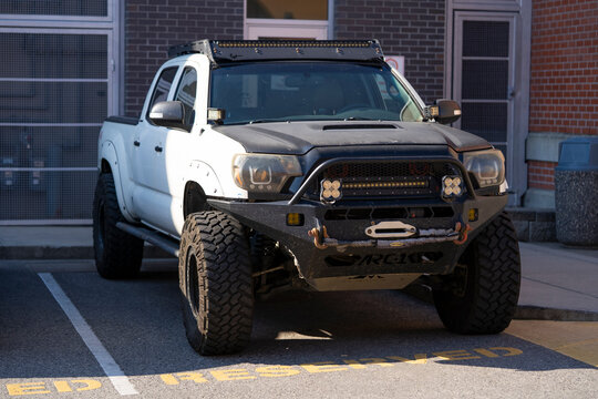 Toyota Tacoma modified for off road use with big tires and extra lights with a steel bumper