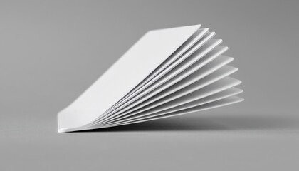A stack of blank white index cards flipping open captured from a macro angle with even lighting against a plain background