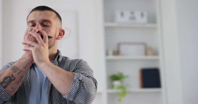 Man playing harmonica at home. Musical instrument