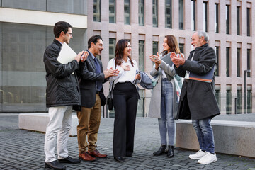 hispanic successful business adult teamwork with different ages walking together in a winter...