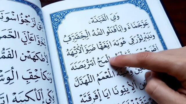 Hand Reading Arabic Islamic Book Quran.