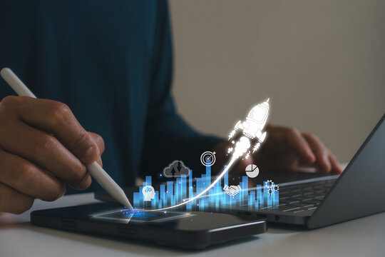 Digital business growth concept. Man use stylus pen on tablet and laptop, virtual charts, rocket launch. Innovation, startup success, technology strategy, AI data analytics, business development.