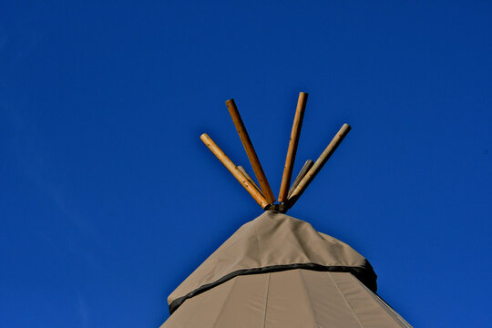 Fake lodge polls on top of tent to add interest 