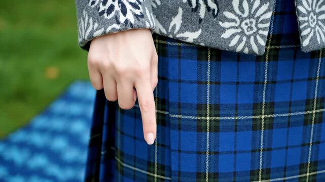 Man Wearing Traditional Scottish Kilt Outdoors.