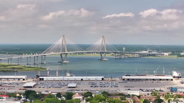 Aerial view of Arthur Ravenel Jr. Bridge in beautiful lowcountry landscapes of Charleston, South Carolina with views of waterfront port seascape - 4K Drone