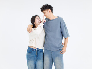Fototapeta premium Portrait asian cute young couple love happy cheerful smile posing embracing in casual clothes hugging on white background studio together relationship good time sweet enjoy moment beautiful romantic.