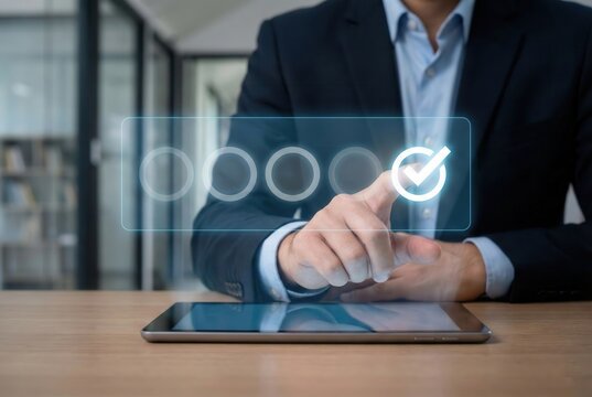 Achieving Perfection: A close-up shot captures the hand of a sharp businessperson making a selection with a glowing check mark icon, which suggests a mark of excellent on a tablet screen.