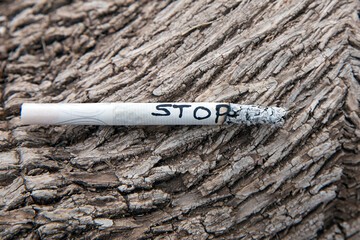 Cigarette with the word STOP written on it, symbolizing the end of smoking