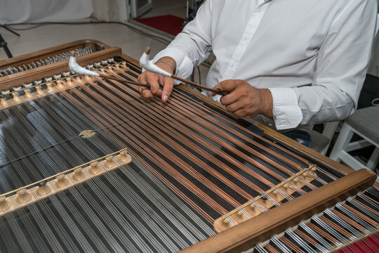 Musician playing traditional old dulcimer (cymbalo ). Retro music instruments  in Romania ,