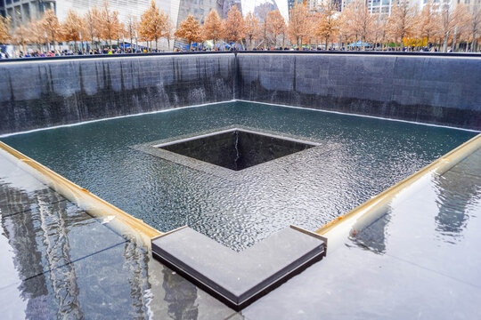 9/11 Memorial reflecting pools with victim names in New York City and Freedom Tower, poignant NYC site of remembrance in American history.
