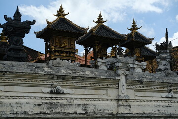 Fototapeta premium Wooden Roofs of a Balinese Temple with Gilded Decorative Elements