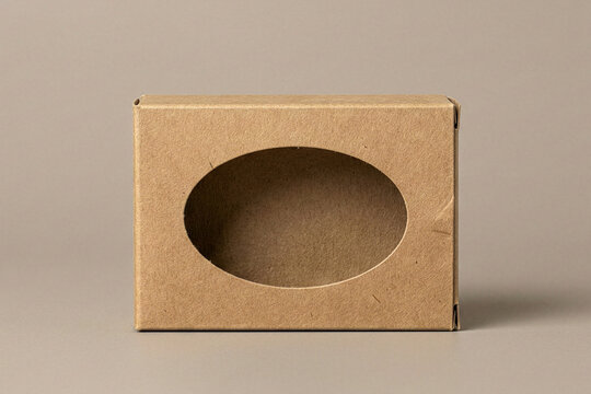 Front view of a brown cardboard box with an oval transparent window for product display