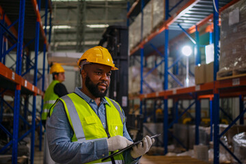 Blue collar workers are working at warehouse.