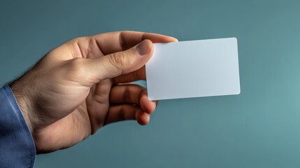 Fototapeta premium Professional hand presenting blank white business card for custom branding and information display.
