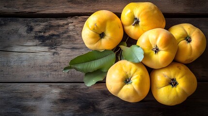 Ripe yellow quince fruits with leaves on rustic wood
