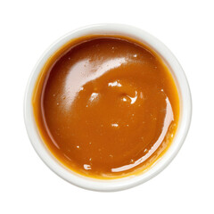 Top view of smooth liquid caramel sauce in a white ceramic bowl against black sweet dessert, Cut Out, Isolated On White Background, Png Transparent