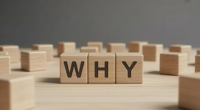 Wooden blocks spelling the word why on a wooden surface with many other blocks surrounding them