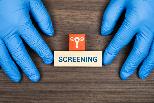 A doctor's hands stacking wooden blocks with a cervix icon; concept of cervical cancer prevention, HPV awareness, and gynecological screening.