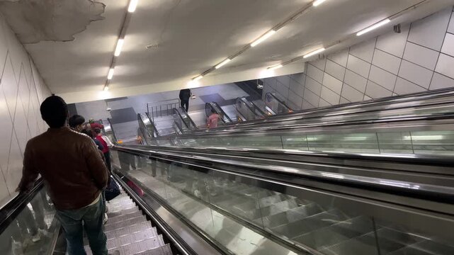 Shot of People using escalator at Metro Station in Delhi, India
