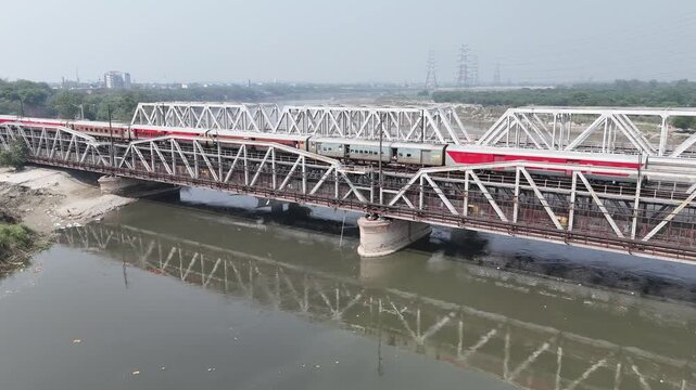 Aerial view of old iron bridge, Loha pul at Yamuna River in Delhi, Train is going on the bridge
