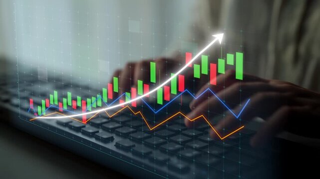 A close-up view of hands on a keyboard with stock market charts displayed, showcasing upward trends in finance and investment analysis, representing market growth. Copula