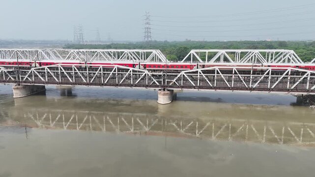 Aerial view of old iron bridge, Loha pul at Yamuna River in Delhi, Train is going on the bridge
