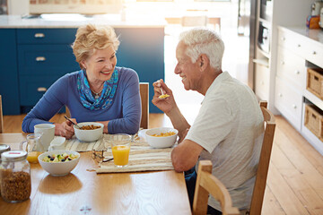 Old couple, smile and eating at dining table with breakfast, healthy food or talk for bonding...