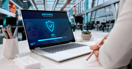 Woman Using Antivirus Software On Laptop To Prevent Cyber Attacks