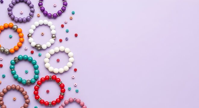 Colorful Handmade Beaded Bracelets Collection on Purple Background with Scattered Beads, Colorful bead necklaces and bracelets are scattered across a light purple surface. Assorted pearls and shiny