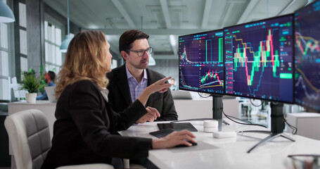 Busy Financial Agent Trading Stocks On Multiple Monitors