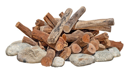 Stacked firewood on a stone fire pit. A rustic outdoor stone fire pit with stacked logs