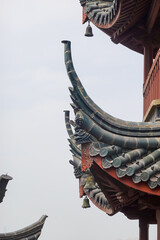 Curved roof tiles and ridge ornaments in close detail today © SILI